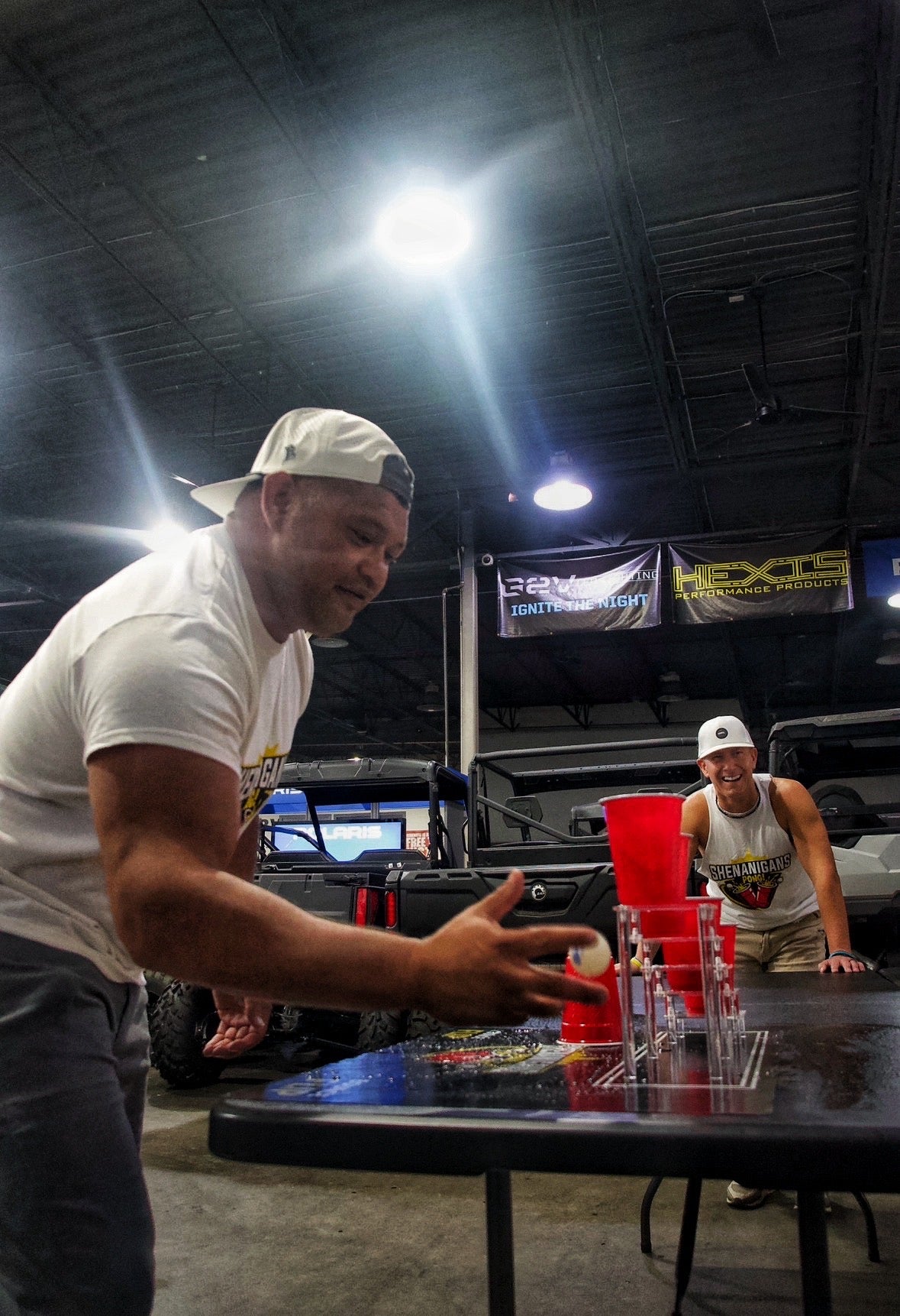 Shenanigans Pong - Fast-Paced Competitive Party Game Shoot, Bounce & Flip Cup Race Game. Includes 2 Silicone Mats, Cups & Balls  completive beer pong.