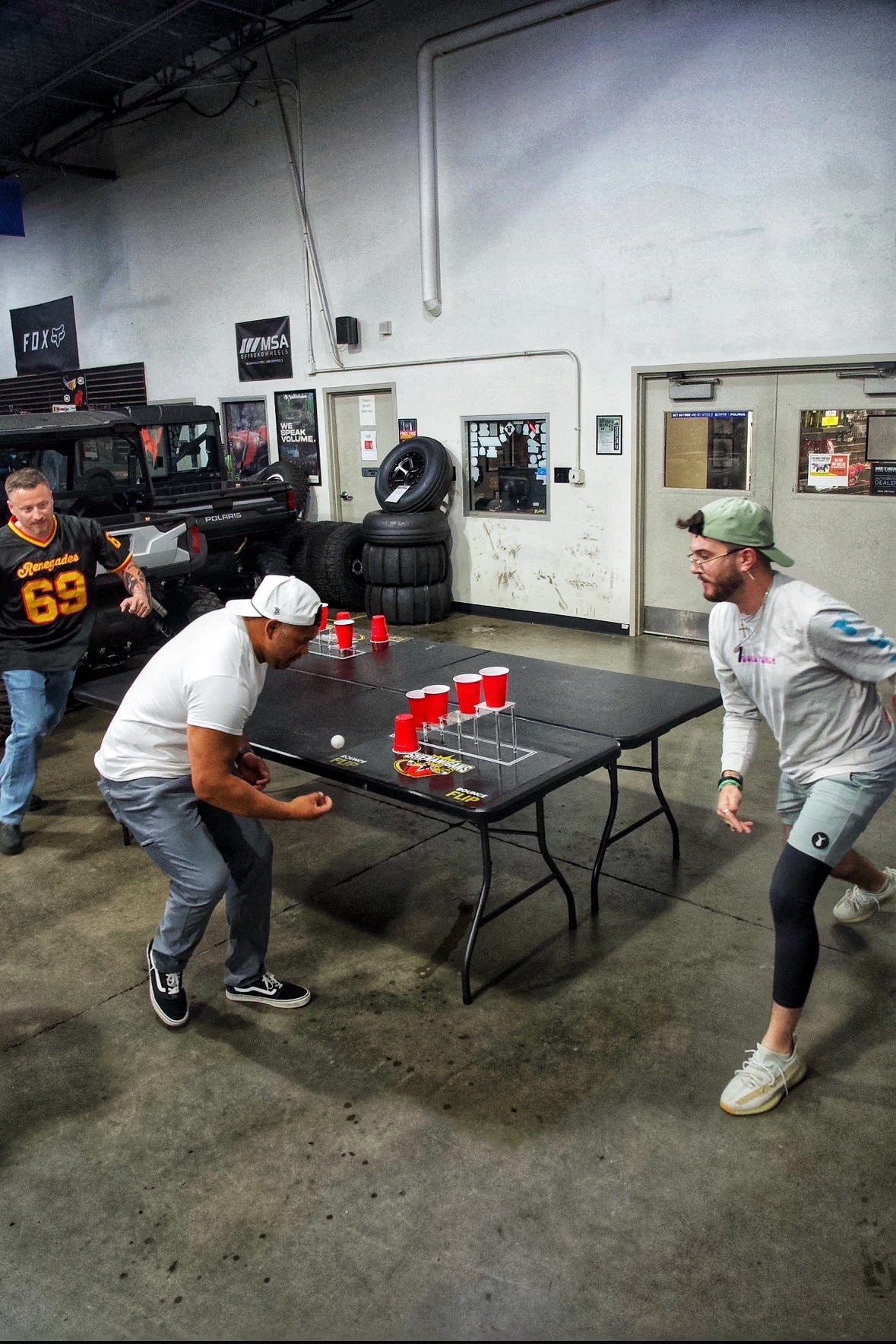 Shenanigans Pong - Fast-Paced Competitive Party Game Shoot, Bounce & Flip Cup Race Game. Includes 2 Silicone Mats, Cups & Balls  completive beer pong.